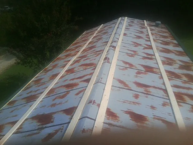Rusted metal roof panels with new wood purlins before replacement — Storm Damage Roof Repair in Ronkonkoma by Roofing Brothers