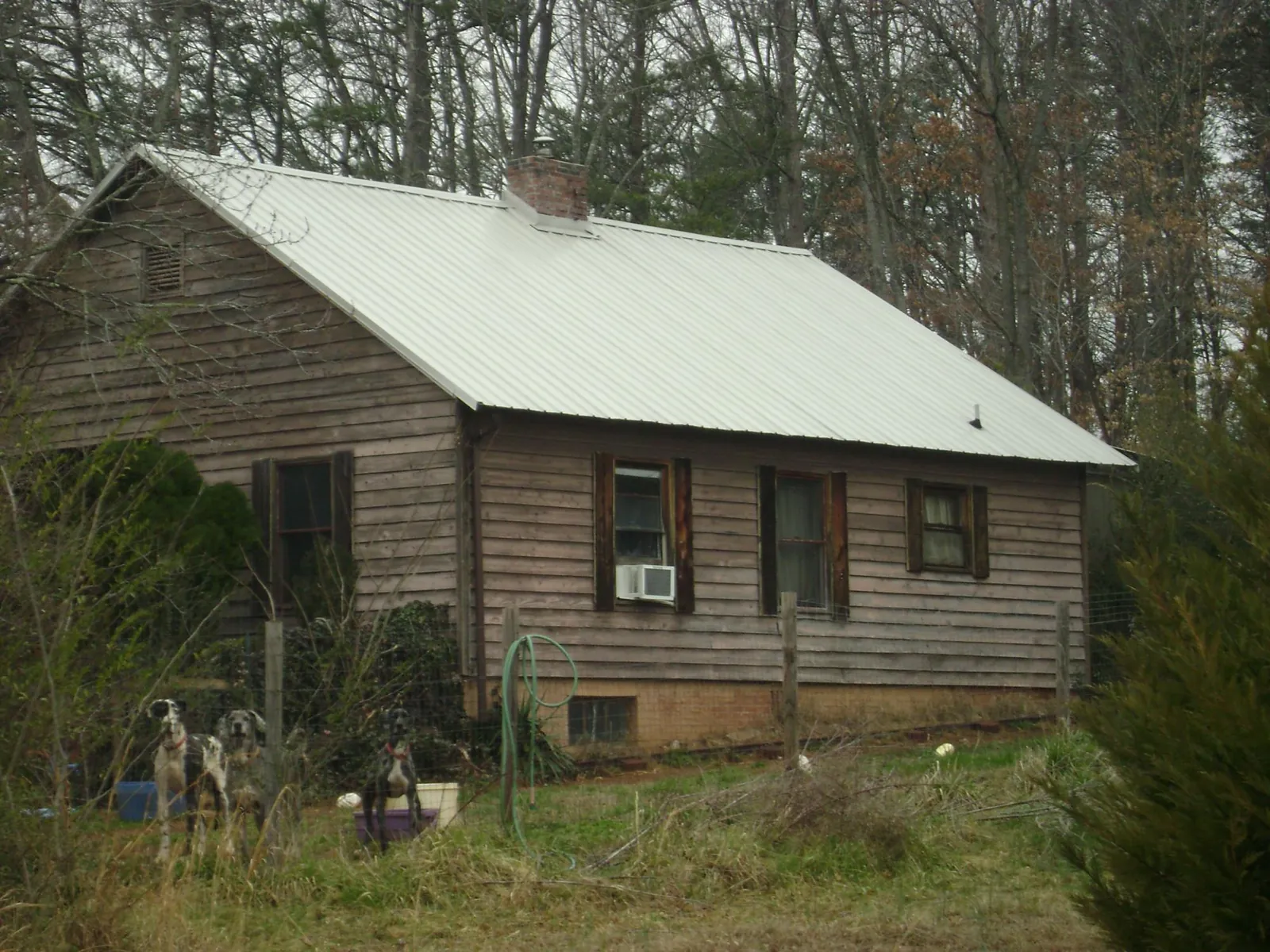 White metal roof on an old wood sided farmhouse, from a Metal Roof Installation job in Ronkonkoma